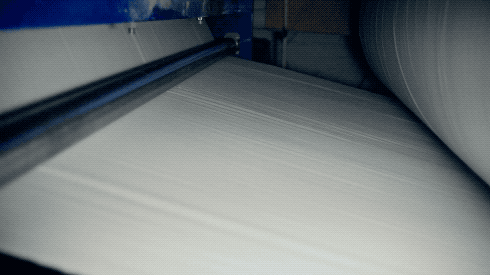 Video footage of a roll of paper being produced that includes a manufacturing flaw